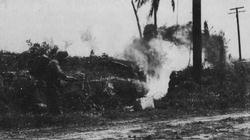 An American soldier flushes out Japanese defenders on Guam with his M1 flamethrower.