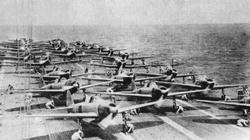 Aboard the Japanese aircraft carrier Akagi, the pilots warm up the engines of their Zero fighters prior to launching for the attack on Pearl Harbour.
