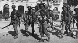 British troops walk through the streets of Pachino, Sicily.