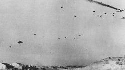 German paratroops drop over Heraklion airfield in Crete. One of the Ju-52's has been hit by anti-aircraft fire.